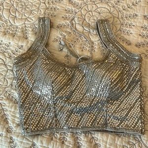 Jazz up a saree or skirt with this silver sequined saree blouse. Size 32. New.